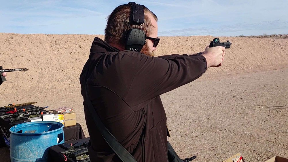 Guy shooting a PSA Dagger
