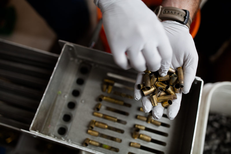 Mathew Unruh, the owner of Round 2 Brass, sorts through fired ammunition to be reloaded or remanufactured in his garage-shop in Leander, Texas. Austin Price/Reporting Texas