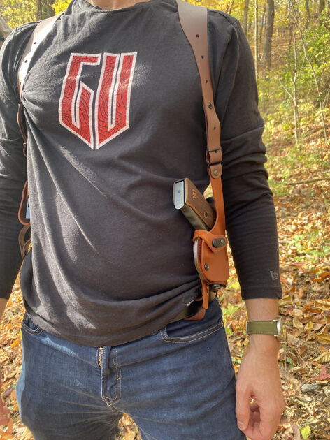 Craft Holsters leather (vertical) shoulder rig strapped down to belt forward of the hip.