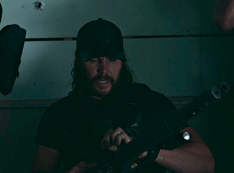 Taylor Kitsch as Ben Edwards reloading a custom tactical shotgun