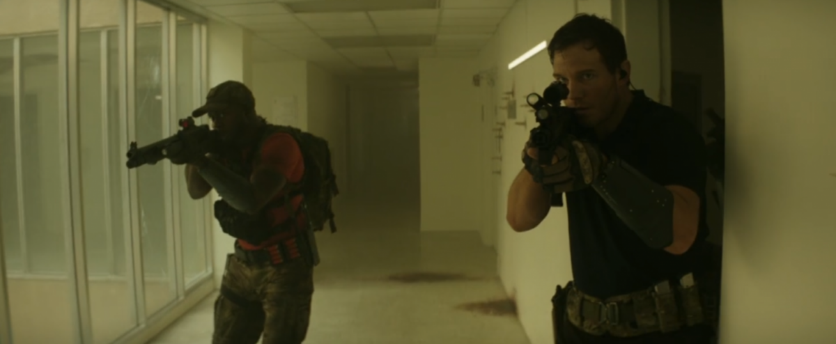Dan Forester (Chris Pratt) and Dorian (Edwin Hodge) clearing a hallway as they move through a structure.