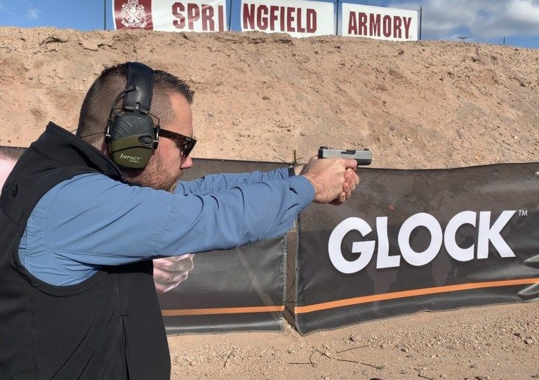 Ryan Cleckner waering hearing and eye protection while shooting 